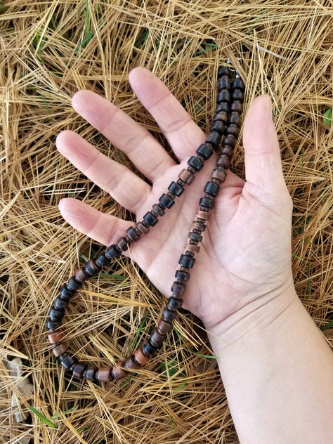 Men's beaded necklace that I handcrafted from mabolo wood and brown coconut shell strung on durable stainless steel cord. Casual island style for any guy who's man enough to wear a necklace! I make these men's beaded necklaces to order in custom sizes (at 1/2 inch increments.) 20" is standard (see "More Information" below for sizing info.) Leave me a note at checkout and I'll make your best fit come true! Mens Beaded Necklaces, Big Men Fashion, Mens Necklace, Mens Fashion Rugged, Casual Jewelry, Wooden Necklace, Wood Necklace, Solitaire Necklaces, Diy Hair Accessories