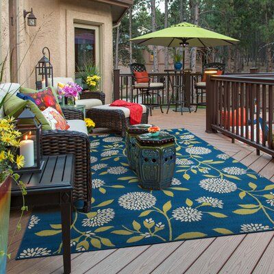 This area rug sets a floral foundation for your indoor or outdoor space. It features an all-over botanical design of leafy dandelion stems in ivory and green hues against a blue background. This rug is power-loomed from polypropylene, and it has a low 0.16" pile height ideal for high-traffic areas like your patio, entryway, or living room. Best of all, it's stain-resistant to hold up to the occasional spill and splash. To care for this area rug, vacuum it without a beater bar and spot-clean it w House Hacks, Shadow Root, Brick Exterior House, Patio Rugs, Living Room Area Rugs, Deck Decorating, Green Area Rugs, Cozumel, Outdoor Area Rug