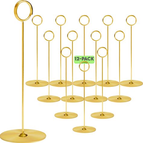 PRICES MAY VARY. PREMIUM QUALITY: 12 Gold place card holders for table with premium quality steel construction. Sleek, durable & fade-resistant. Each 8-inch tall unit has a 2.8-inch diameter base for stability. No chipping or cracking issues. STYLISH: These photo holders for tables are stylish & versatile. Ideal as sign holders for table tops, they add finesse to any occasion - formal or every day. Perfectly complements centerpieces, ornaments & elegant table settings. VERSATILE CARD DISPLAY: Ou Decorative Centerpieces, Tall Unit, Gold Place Cards, Table Number Stands, Recipe Holder, Table Number Holders, Table Card Holder, Place Card Holder, Food Signs