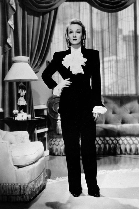 Marlene Dietrich While her efforts didn't directly fight for women's rights, Dietrich made a contribution to feminism through fashion. The Hollywood actress wore trousers and men's suits during a time where it was considered extremely scandalous and taboo; both on screen and privately, once almost being arrested for wearing pants in public during the 1930s. Dietrich's way of dressing went on to influence generations of women after her, lending many the confidence and power of wearing a suit. Famous Feminists, Adrienne Ames, Chantal Thomass, Jean Harlow, Old Hollywood Glam, Marlene Dietrich, Power Suit, Hollywood Glam, Old Hollywood Glamour