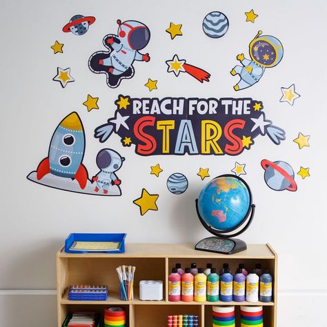 Blast off and spark curiosity and fun with this classroom wall statement piece that's truly out of this world! Featuring astronauts, a rocket, planets and stars, this is sure to be a perfect addition for classroom supplies that have a space or astronomy theme. Includes 24 cutouts on 5 sheets. Cardstock. (5 sheets per unit) Sheets, 24 1/2" x 16". © OTC  Space Wall Statement Piece Instructions Astronaut Classroom Theme, Space Classroom Theme, Wall Statement Piece, Space Bulletin Boards, Space Theme Classroom, Wall Statement, Space Week, Space Classroom, Planets And Stars