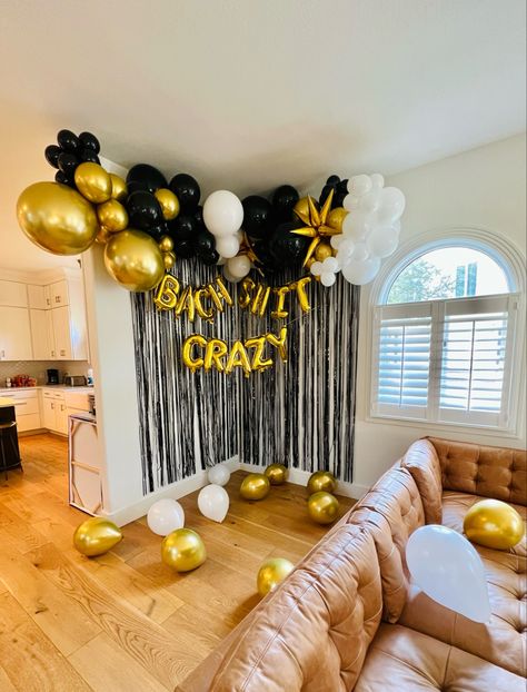 Gold, white and black balloon garland with Bach shit crazy gold letter balloons and a black tinsel curtain, installed in an Airbnb in Austin Texas Black And Gold Bachelorette Party Decor, Balloon Arch Bachelorette, Black And Gold Bachelorette Party, Black And White Balloon Arch, White Balloon Arch, Gold Bachelorette Party Decorations, Austin Bachelorette Party, Austin Bachelorette, Black And White Balloons