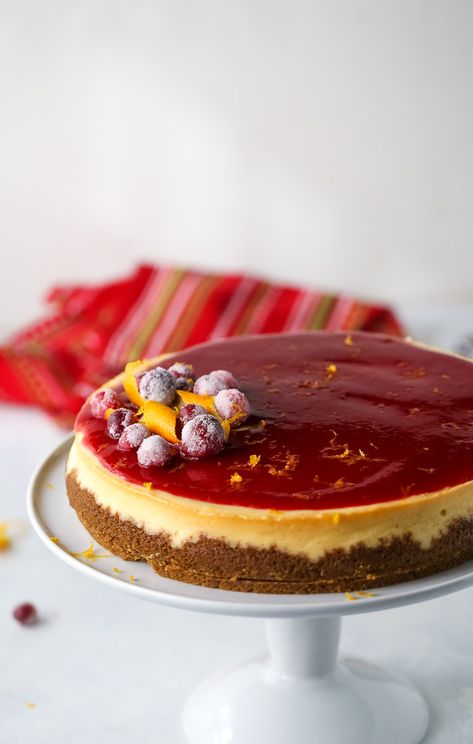 This cranberry orange cheesecake recipe is a MUST this holiday season. With a gingersnap crust, a decadent and creamy orange cheesecake is topped with a sweet-tart cranberry sauce. #cheesecake #cranberrycheesecake #orangecheesecake Sauce For Cheesecake, Peppermint White Chocolate Cheesecake, Cranberry Orange Cheesecake, Orange Cheesecake Recipes, Christmas Cheesecake Recipes, Orange Cheesecake, Cranberry Orange Sauce, Cranberry Cheesecake, Holiday Baking List