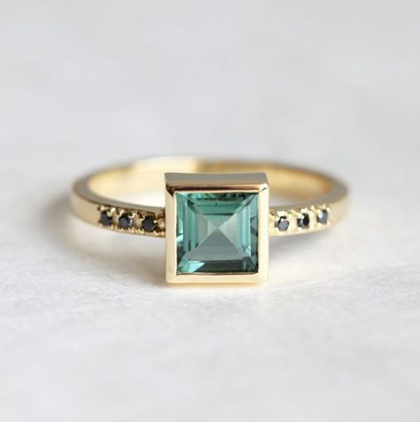 With a princess cut + black diamond side stones, this ring has endless edgy appeal that will go over big with any modern bride. Budget Friendly Engagement Rings, 18k Gold Engagement Ring, Tourmaline Engagement Ring, Bijoux Art Nouveau, Engagement Rings Princess, Green Tourmaline Ring, Handmade Engagement Rings, Gold Diamond Wedding Band, Morganite Ring