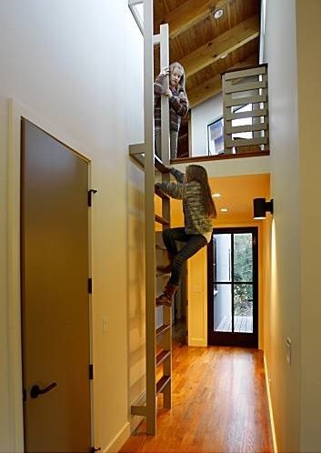 Berkeley-based designer Gustave Carlson used reclaimed teak flooring, custom powder-coated aluminum windows and doors from Bonelli Windows & Doors in S Attic Game Room, Attic Wardrobe, Slanted Walls, Attic Lighting, Attic Playroom, Aluminium Windows And Doors, Loft Stairs, Small Attic, Attic Conversion