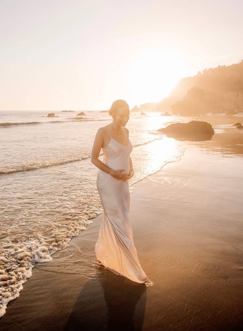 Sydne Style shares dreamy sunset maternity photoshoot ideas at golden hour White Dress Ocean Photoshoot, Satin Maternity Dress Photoshoot, Maternity Photography Golden Hour, Dreamy Beach Photoshoot, Dreamy Maternity Shoot, Golden Hour Maternity Shoot, Maternity Shoot Beach, Sunset Photoshoot Ideas, Beach Maternity Shoot