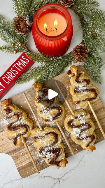 Kamry Vincent | Kentucky Creator on Instagram: "How cute are these Nutella Christmas Tree Pastries?!🎄They are so simple to make! Share this fun idea with a mama! 😊

Ingredients 
•2 Sheets of Puff Pastry 
•Nutella 
•Egg
•Powdered Sugar 
•Skewers 

Directions 
1)First, preheat oven to 400 degrees Fahrenheit. 
2) Unroll puff pastry and spread on Nutella. 
3)Lay the other sheet of puff pastry on top and then use a pizza roller to slice into long 1 inch wide strips.
4)Fold your strips of pastry into a Christmas tree and put skewer through the middle of the pastry.
5)Brush tops with egg wash. 
6)Bake in oven for 15-20 minutes.
7)Sprinkle with powdered sugar and enjoy! 

——
#christmas #christmastreats #easyrecipe #momsofinstagram #christmasfood" Nutella Christmas Trees, Nutella Christmas Tree Puff Pastry, Nutella Christmas Tree, Nutella Christmas, Egg Wash, Crescent Rolls, A Pizza, Merry Little Christmas, Puff Pastry