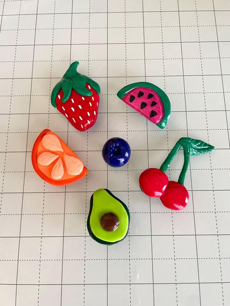 Brighten up your kitchen, office, or dorm room with these adorable handmade clay magnets! Each magnet is delicately hand-sculpted from polymer clay, baked to perfection, and finished with a glossy glaze. The clay is securely attached to sturdy magnets (0.5" / 12.7 mm diameter) with superglue gel. The clay strawberry and cherries are both approximately 2" (L) x 1.5" (W).  The clay orange and watermelon are both approximately 1.5" (L) x 1" (W). The clay blueberry is approximately 0.75" (L) x 0.75" Fruit Fridge Magnets, Cherry Clay Magnet, How To Clay Art, Air Dry Clay Projects Magnets, Fruit Clay Magnets, Simple Things To Make Out Of Clay, Art Things To Sell, Diy Fridge Magnets Creative, Polymer Clay Watermelon