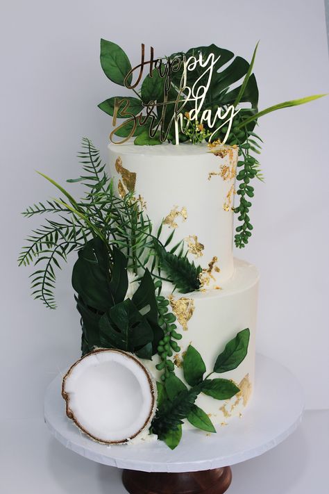 All white cake, green and gold details Leaf Birthday Theme, Coconut Theme Cake, Plant Theme Cake Ideas, Birthday Cake Tropical Theme, Greenery Birthday Cake, Birthday Cake Plants Theme, Modern Tropical Wedding Cake, Botanical Birthday Cake, Tropical Party For Men