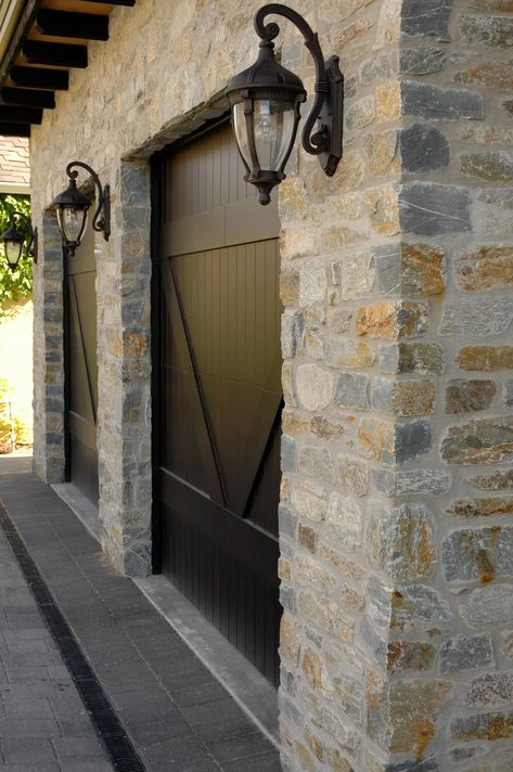 Natural Ledgestone veneer is installed on the exterior of the garage. Stage Reference, Brick Garage, Exterior Stone Veneer, Stone Cladding Exterior, Stone Exterior Houses, Garage Door Types, Garage Exterior, Garage Door Design, Farmhouse Aesthetic