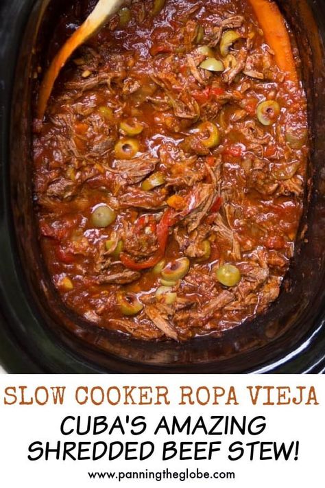 This scrumptious shredded beef stew, called Ropa Vieja, is the national dish of Cuba and it's perfect for the slow cooker: tender shredded beef stewed with peppers, tomatoes and delicious spices. Traditionally served with rice, black beans and fried plantains. #RopaVieja #SlowCooker #Crockpot #BeefStew #StewRecipe Crockpot Beefstew, Shredded Beef Stew, Fried Plantains, Cuban Dishes, National Dish, Shredded Beef, Cuban Recipes, Latin Food, Slow Cooking