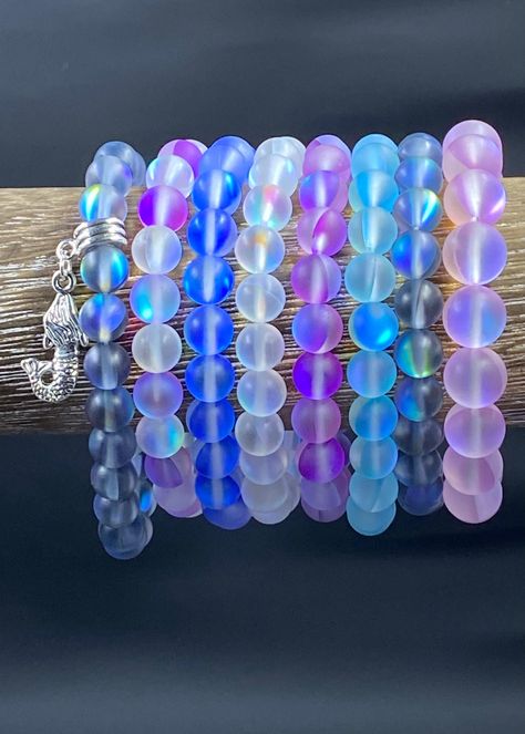 BEAUTIFUL AND STUNNING MERMAID AURA BRACELET emits an iridescent shine and shimmer. These bracelets create an amazing prism of color as the light hits them.   This listing and pricing is for one single strand bracelet. Pictures with more bracelets are to show how they look stacked and to show the various colors and finishes.  SIZING: Every piece is made to order.   Available sizes include 6in, 6.5in, 7in, 7.5in, or size 8in bracelet (Custom sizes available! Just message me). MOST COMMON WRIST SIZE IS 7 IN!  ENTER SIZE IN PERSONALIZATION SECTION. If you need help determining wrist size; take a strip of paper or a string and wrap it around your wrist. Pinch at the ends, take off, and lay next to a ruler to get a precise measurement. Bracelets fit snugly. If you prefer more of a dangle look, Bracelet Pictures, Sea Stuff, Crystal Bead Bracelet, Pearl Necklace Choker, Eyeliner Makeup, Crystal Beads Bracelet, Bracelet Ideas, Stretchy Bracelets, Black Jewelry