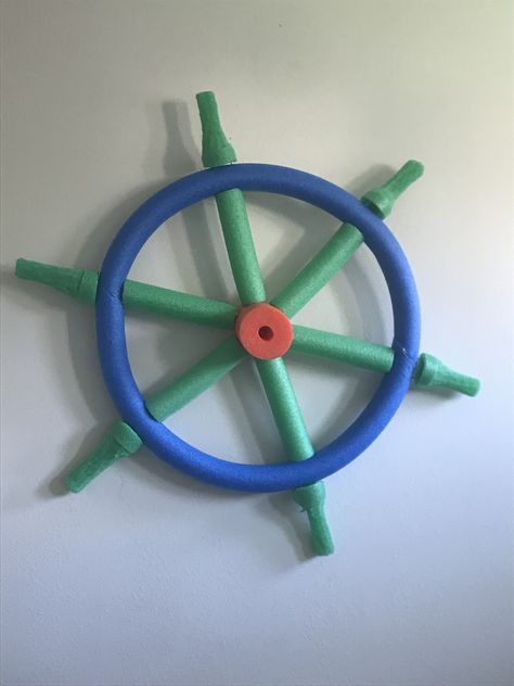 Ship’s helm made of pool noodles Pool Noodle Pirate Ship, Diy Ships Wheel, Diy Pirate Ship Wheel, Pirate Ship Wheel Diy, Shipwreck Diy, Diy Ship Wheel, Pirate Ship Prop, Pirate Ships Diy, Pirate Ship Wheel