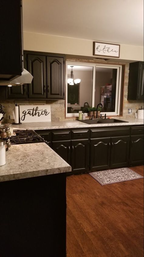 Small Black Kitchen Farmhouse, Black Cabinets Tan Walls, Black Kitchen Inspiration Farmhouse, Black Cabinets Tan Countertops, Updated Mobile Home Kitchen, Black Kitchen Cabinets With Backsplash, Cream And Brown Kitchen Decor, Black Mobile Home Interior, Oak Cabinets Painted Black