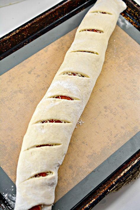 Carefully roll the dough lengthwise into a log. Cut slits into the dough on top of the log, and place onto a baking sheet. Pizza Logs, How To Make Pepperoni, Pepperoni Bread, Pepperoni Rolls, Easy To Make Snacks, Game Day Appetizers, Pizza Rolls, Creamy Cheese, Pizza Bread