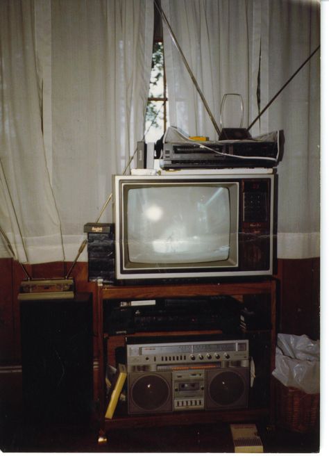 Semi-state-of-the-art home theater set-up, early 1980s. Two VHS decks to copy rental movies. Stereo VCR routed to boombox routed to speakers for "Hi-fi" sound. 19" TV with LCD display. No using the pliers to change channels on this setup! 70s Movie Theater Aesthetic, 1980s Tv Set, Vhs Home Video Aesthetic, Vhs Tv Aesthetic, 80s Tv Aesthetic, Early 80s Aesthetic, 70s Home Office, Vhs Tv, 1980s Boombox