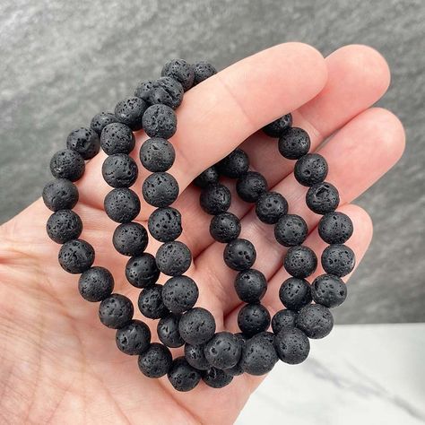 "Polished beads are made from basalt (volcanic rock).  8.5mm Bracelets Sized: 6.25\" - 6.50\"  Our crystals and minerals are natural, and some are shaped by hand. Because each is unique and one of a kind, some may come with small chips or imperfections. Any appearances of cracks are one of the natural characteristics of this crystal or mineral and not because of damage. We select all crystals and minerals by hand. We choose the most unique and highest quality we can find. We try to take images/v Silver Bracelet Designs, Lava Bead Bracelet, Volcanic Rock, Lava Bead, Lava Stone, Beaded Stretch Bracelet, Crystal Items, Stretch Bracelet, Bracelet Sizes