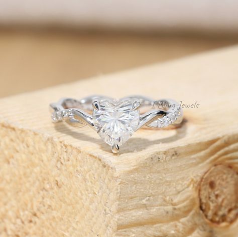 Moissanite Solitaire Accents Stone Ring / Heart Cut Moissanite Eternity Ring / Twisted Band Ring for Your Girlfriend / Wedding Diamond Ring / Diamond Proposal Ring / Heart Cut Ring / Heart Diamond Ring / Heart Moissanite ✥ SKU No.: IBS277 ✥ 𝐌𝐚𝐢𝐧 𝐒𝐭𝐨𝐧𝐞 𝐃𝐞𝐭𝐚𝐢𝐥𝐬: ➻ Shape: Heart ➻ Dimension: 5.92*5.97*3.62 MM ➻ Weight: 0.70 CT ➻ Color: Colorless ➻ Clarity: VVS ✥ 𝐒𝐭𝐨𝐧𝐞 𝐃𝐞𝐭𝐚𝐢𝐥𝐬: ➻ Shape: Round ➻ Dimension: 1.00 MM (16 pcs) ➻ Weight: 0.10 TCW ➻ Color: Colorless ➻ Clarity: VV Moissanite Heart Ring, Wedding Rings With Hearts, Heart Shaped Rings Engagement, Ring Twisted Band, Heart Shaped Wedding Rings, Heart Cut Ring, Cute Promise Rings, Heart Shaped Diamond Ring, Heart Wedding Rings