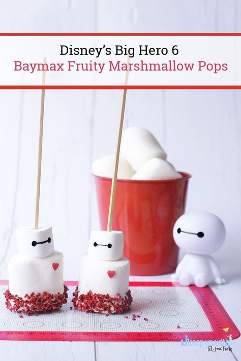 Image shows a plastic Disney's Big Hero 6 Baymax figure sat on a white woodent tabletop, next to a red tin bucket of large marshmallows. In front of him are two Disney's Big Hero 6 Baymax Fruity Marshmallow Pops on sticks, ready to be eaten. Disney Marshmallow Pops, Big Hero 6 Party Food, Big Hero 6 Snacks, Big Hero 6 Food, Baymax Party, Movie Treats, Marshmallow Pops Recipe, Japan Recipes, Quick And Easy Sweet Treats