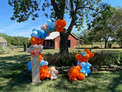 Orange and blue “little cutie on the way” boy baby shower balloon arch Orange And Blue Aesthetic Party, Little Cutie On The Way, Shower Balloon Arch, Cutie On The Way, Orange Confetti, Baby Shower Balloon Arch, Indian Baby Showers, Baby Shower Background, Puppy Birthday Parties