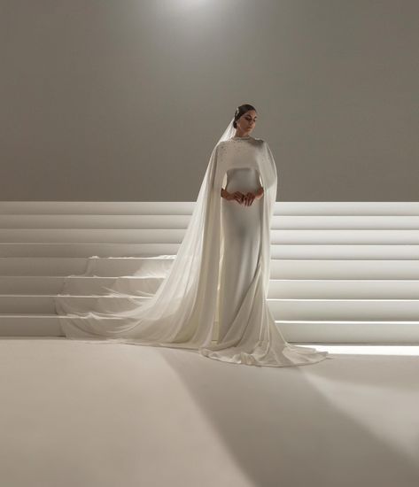 JE SERAI LA Long white crepe dress and asymmetrical cape embroidered with crystals. White georgette crepe veil embroidered with… | Instagram White Crepe Dress, Asymmetrical Cape, Dress With Veil, Asymetrical Dress, Crystals White, Cape Wedding Dress, Stephane Rolland, Wedding Dress With Veil, Classic Wedding Dress