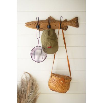 This wooden trout coat rack is perfect for the lake house! It will hold your gear or outerwear wherever you go fishing. This coat rack also makes a great gift for fishing enthusiasts. It's perfect for your back porch or as an addition to your fishing shrine. | Bay Isle Home™ Nevis Solid Wood 3 - Hook Wall Mounted Coat Rack in Wood / Metal in Brown | 7 H x 24 W x 2.5 D in | Wayfair Vintage Fishing Decor, Transitional Style Decor, Coat Rack With Storage, Coat Rack Hooks, Kids Playroom Furniture, The Lake House, Fishing Decor, Lake House Decor, Vintage Fishing