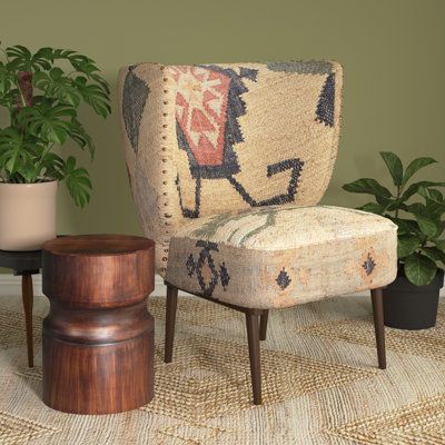 This plush armchair showcases an eclectic array of patterns that remind us of Southwestern-inspired designs. The minimal frame is crafted solid acacia wood, and it rests on slim tapered legs for a sleek look. This chair is wrapped in a jute and cotton blend in hues of beige, green, and black. The thick seat and flared back are filled with foam for just the right amount of support while you read or watch TV. Plus, this armchair measures 30" tall, making it just the right size for a reading nook. Rustic Accent Chair, Southwestern Living Room, Plush Armchair, Western Furniture, Rustic Table, Western Decor, Furniture Covers, Shop Chair, Chair Pads