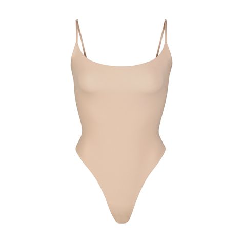 With its wide scoop neckline and low back providing the perfect foundation under clothing, this Cami Bodysuit is an essential wardrobe foundation. Features a high cut leg opening and thong back that remains invisible under clothing. Under Clothing, High Neck Bodysuit, Cami Bodysuit, Perfect Foundation, Size 16 Dresses, Body Shapers, High Cut, Low Back, Shapewear