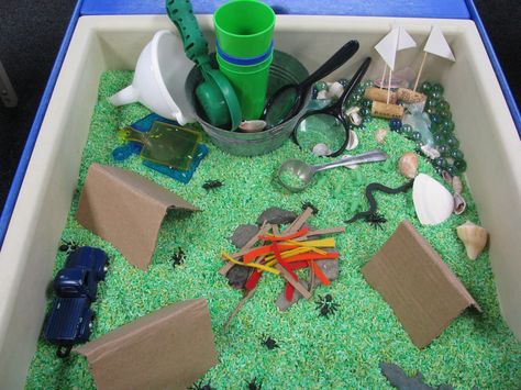 Camping Theme Sensory Table Green Rice blue marbles/lake cardboard tents, fire/cardboard, red and orange felt strips rocks, insects, boats Camping Theme Week Preschool, Camping Light Table Activities, Montessori Camping Theme, Sensory Camping Activities, Reggio Camping Theme, Camp Sensory Bin, Camping Sensory Table, Dramatic Play Camping Theme, Camping Theme Sensory Bin