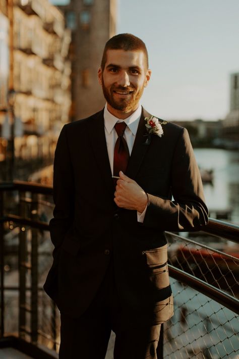 This urban winter wedding featured classic black and white groom attire with a burgundy tie. See more inspo on the blog at nikkikate.com! Black Suit And Burgundy Tie, Black Suit With Burgundy Tie, All Black Suit With Burgundy Tie, All Black Suit Burgundy Tie, Black Tux Burgundy Tie, Black Tux With Burgundy, Black Suit Burgundy Tie Wedding, Burgundy And Black Groom, Black Suit With Maroon Tie