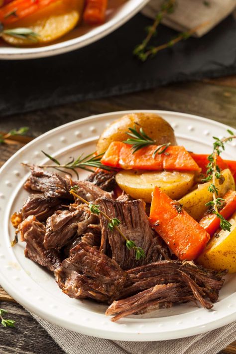 Chuck roast cooked in the oven as a pot roast and served shredded with vegetables on a plate Chuck Roast In Oven, Farm Meals, Roast In Oven, Shredded Beef Recipe, Slow Cooker Shredded Beef, Crockpot Pot Roast, Shredded Beef Recipes, Braised Chicken Breast, Ground Beef And Cabbage