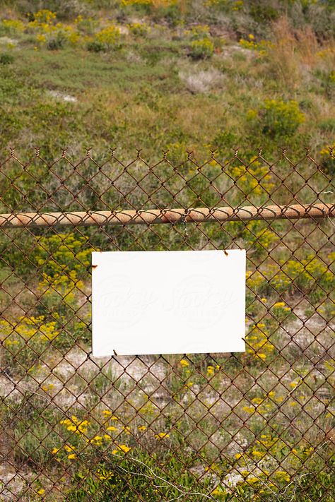 A blank white mockup sign on an old rusty chain-link fence in front of an empty field. White Sign, Paper Background Design, Old Fences, Chain Link Fence, Art Competitions, Blank White, Paper Background, Background Design, Chain Link