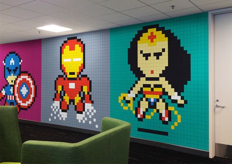 Desperately need to do this in my office.  8 Bit Superheroes with Sticky Notes in an Office  Reddit user, known as Bruck7, shared a wall installation of sticky notes that he made because he was bored about seeing grey walls everyday. He used 8024 sticky notes to shape frescos of pop culture heroes such as Wonder Woman, Superman, Batman, Spiderman and Captain America. Post It Art, Google Office, Office Mural, Superhero Wall, 8 Bit Art, Post Its, Notes Art, Library Programs, Cool Office