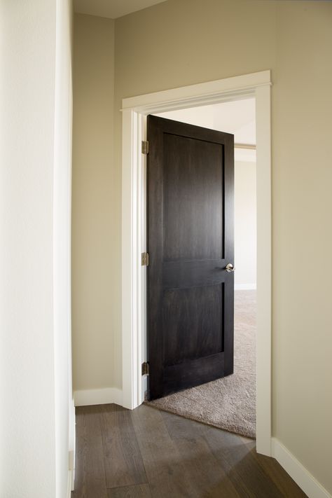 Interior Doors | updating the doors in your home can make a significant impact on the overall appearance. Here, two panel poplar doors, prefinished in espresso and cased in prefinished white trim with an off-white wall makes for a high contrast, beautiful space | Bayer Built Woodworks, Inc. Stained Front Door, 6 Panel Interior Doors, Stained Wood Trim, White Interior Door, Mahogany Interior, Interior Window Trim, Dark Doors, Painted Interior Doors, Off White Walls