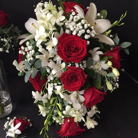 Cascade bouquet of white lilies, red roses, white orchids and baby's breath with eucalyptus Red Rose And Lily Bouquet, Juniper Wedding, Baby's Breath Bridal Bouquet, Rose And Lily Bouquet, Gypsophila Bouquet, Mums Birthday, Xmas Wedding, White Flower Bouquet, Red Wedding Theme