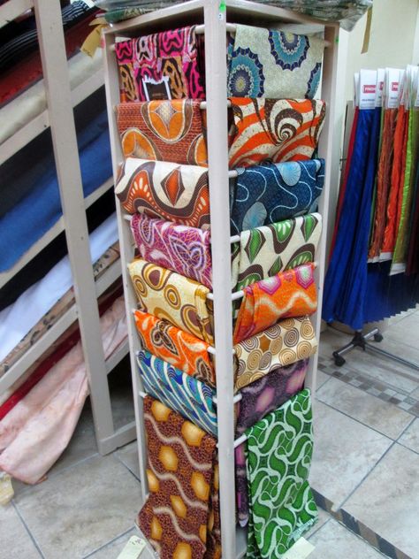 Fabric Shop Display, Wildebeest Migration, Color Block Curtains, Scarves Store, Fabric Store Displays, Fabric Store Design, African Shop, Store Shelves Design, Latest Sofa Designs