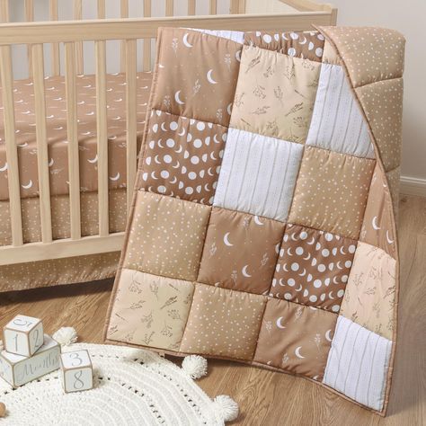 PRICES MAY VARY. Earth tone shades of beige and white seamlessly blend with floral and celestial elements to add a bohemian touch to your baby boy or girl nursery. This gender neutral baby bedding set includes a reversible crib comforter, fitted crib sheet, and a dust ruffle. The patchwork boho crib comforter is reversible and features a harmonious blend of suns, moons, and stars with a reverse side that matches the crib skirt. The fitted crib sheet is designed to fit a standard size crib mattre Celestial Bedding, Baby Room Closet, Boho Celestial, Crib Comforter, Neutral Quilt, Boho Comforters, Baby Crib Bedding Sets, Moons And Stars, Crib Skirt