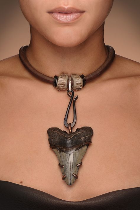 Neckpiece by Chris Carlson. Megalodon (prehistoric shark) tooth, leather, antler, forged copper hook and setting, opalized ammonite (at back closure not visible in photo). Model, Bianca. Megladon Tooth Necklace, Animal Tooth Jewelry, Shark Tooth Jewelry, Shark Teeth Crafts, Opalized Ammonite, Shark Teeth Jewelry, Sharks Teeth, Shark Tooth Pendant, Diy Jewelry Pendants