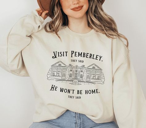 Visit Pemberley They Said He Won't Be Home They Said Sweatshirt Let your love for Jane Austen's literary world shine as you proudly display your admiration for Pemberley, one of the most iconic settings in literature. Whether you're attending a book club gathering, exploring your local library, or simply enjoying a leisurely day, this Pride and Prejudice sweatshirt is the ideal companion. ✧ For more bookish crewnecks, click here: https://www.etsy.com/shop/TheBookishCollective?section_id=36312919 Bookish Fashion, Pride And Prejudice Sweatshirt, Jane Austen Gifts, Dark Academia Clothing, Jane Austen Books, Pride And Prejudice, Jane Austen, Sweat Shirt, Womens Shirts