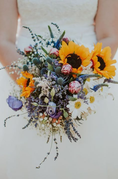 Picture Of a beautiful and colorful wedding bouquet of pink and purple blooms,chamomiles, thistles, sunflowers and baby’s breath is amazing Daisy Bouquet Wedding, California Gardening, Selling Plants, Colorful Wedding Bouquet, Wildflower Wedding Bouquet, Wedding Flowers Sunflowers, Sunflower Wedding Bouquet, Sunflower Themed Wedding, Sunflowers And Daisies