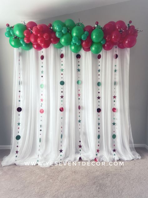 Love this festive backdrop! To learn how to make this backdrop, click on the link below to see the YouTube tutorial. All of the materials are listed in the description of the video. Don’t forget to subscribe to see all of our latest decoration ideas! Christmas Balloon Backdrop, Christmas Party Background, Balloon Garland Tutorial, Backdrop With Lights, Christmas Party Backdrop, Garland Tutorial, Christmas Balloon Decorations, Grinch Christmas Party, Almost Christmas