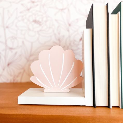 "If you're looking for one of a kind decor for your sweet mermaid fan, these carefully handcrafted mermaid tail and pink shell bookends are the perfect addition to her collection.   A beautiful way to frame her favorite books on a shelf or dresser, these are well made and sturdy with rubber pads to prevent sliding and scuffing.  Images are hand painted on the front and back and sealed with a clear coat to keep them protected.   These bookends measure about 7.5\" x 7.5\" x 3.75\" deep.  Each set is handmade, please allow about 3-5 business days for production.  Options include:  -One shell and one mermaid tail -Two shells, or -Two mermaid tails.   Selected your option, quantity, and add to cart.  A perfect gift for your daughter, or for a loved one's new baby.  They're sure to enjoy this th Mermaid Nursery Theme, Bedroom Shelf Decor, Little Mermaid Nursery, Nursery Room Decor Girl, Kids Bedroom Accessories, Bedroom Shelf, Shelf Decor Bedroom, Gift For Baby Girl, Mermaid Bedroom