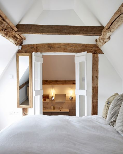 When building spaces into the roof you have the opportunity to expose some of the structure and to leave it that way. If you are lucky enough to live in a period property with beautiful original beams then use your loft conversion to expose them and add a sense of warmth and charm. In this cosy principal bedroom suite, the bathroom leads off the sleeping quarters through compact double doors – the two rooms really make the most of the full length of the space while the sloping sections prov... Loft Conversion Layout, Loft Conversion Bedroom, Small Ensuite, Sleeping Quarters, Loft Bathroom, Roof Shapes, Attic Space, Period Property, Dormer Windows