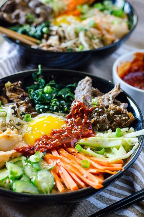 This Korean Bibimbap recipe is an Asian food lover's dream - a bowl full crispy rice, sautéed veggies, fried egg & some thinly sliced beef, drizzled with a spicy sauce. Bim Bop, Bulgogi Bibimbap, Korean Bibimbap, Bibimbap Recipe, Egg Recipes For Dinner, Sautéed Veggies, Bowl Meals, Mouthwatering Food, Korean Rice