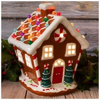 Dimensions: 10" H x 7.16" W x 7.48" D Power Source: Corded Electric Material: Ceramic & Glass Color: Brown, White, Red & Green Pattern: Stripes Care & Safety: Indoor Use Only Quantity: 1 Make your Christmas village display look brighter when you add this Light Up Gingerbread House! This charming ceramic house looks exactly like a gingerbread house, but without the frosting! Its colorful round spheres on top light up and give off a vibrant appearance. Simply turn on the lights to make your holida Up Gingerbread House, Christmas Fairy Lights, Cookie House, Berry Garland, Christmas Village Display, Village Display, Christmas Decorations Diy Outdoor, Diy Christmas Decorations Easy, Decor Pillows