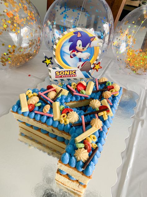 Sonic the Hedgehog Number Cake with kitkat toppings, pocky, yellow & green fruitloops, and dried strawberries 😋 Number 5 Sonic Cake, Sonic Number Cake, Diy Sonic Cake, Simple Sonic Cake, Sonic The Hedgehog Cupcakes, Sonic The Hedgehog Birthday Cake, Number 4 Cake, Hedgehog Cupcake, Sonic Birthday Cake