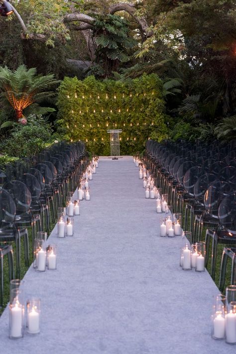 White aisle runner with multiple hurricane candles by the seating. Nighttime Wedding Ceremony, Aisle With Candles, Night Wedding Ideas, Wedding Ideas Indoor, Nighttime Wedding, Entertainment Decor, Mindy Weiss, Night Time Wedding, Young Wedding