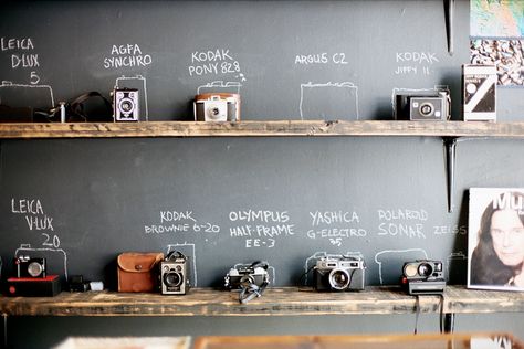 camera storage. been trying to find a smart/non-eye-sore way to store my stuff. Fotocamere Vintage, Decor Studio, Old Cameras, Chalkboard Wall, Chalkboard Paint, Design Sponge, Vintage Cameras, Vintage Camera, Studio Space