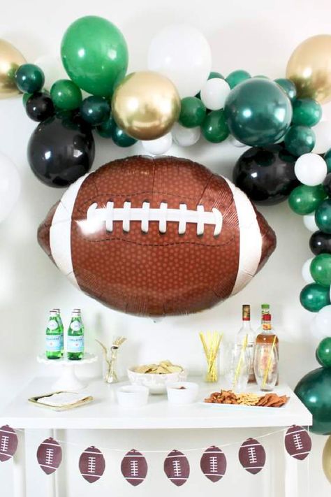 Score a touchdown with a football-themed 50th birthday party for the avid sports fan. Deck out the venue in team colors, hang banners and set up a mini football field for guests to play. Serve classic game day food like nachos and sliders, and have a football trivia challenge to test guests' knowledge of the sport. See more party ideas and share yours at CatchMyParty.com Football Party Drinks, 50th Birthday Party Themes, Football Themed Party, Football Balloons, Super Bowl Party Ideas, Football Party Decorations, Football Banquet, Football Party Ideas, Football Baby Shower