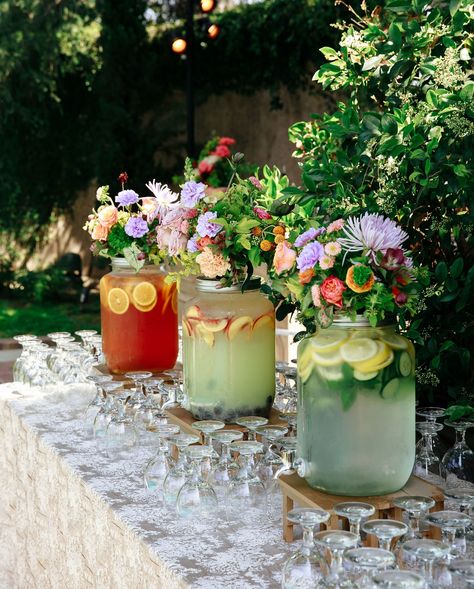 three beverage dispensers are decorated with flowers and spa water Spring Wedding Drinks, Garden Cocktail Hour Wedding, Self Service Bar Wedding, Margarita Bar Wedding, Floral Sangria, Cocktail Hour Wedding Ideas, Wedding Sangria, Cocktail Style Wedding Reception, Wedding Cocktail Hour Ideas